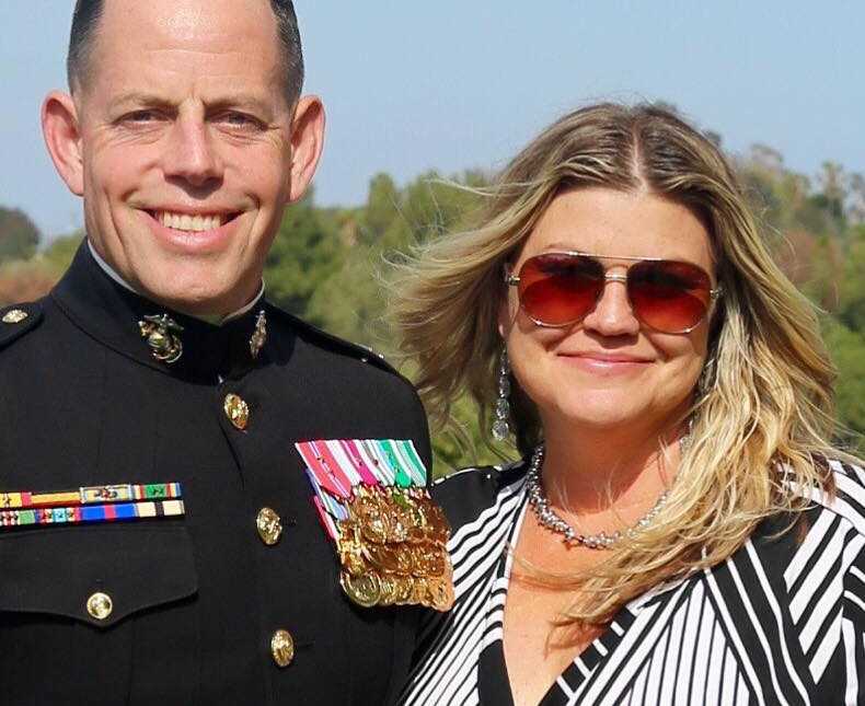 Marine smiles in uniform with wife