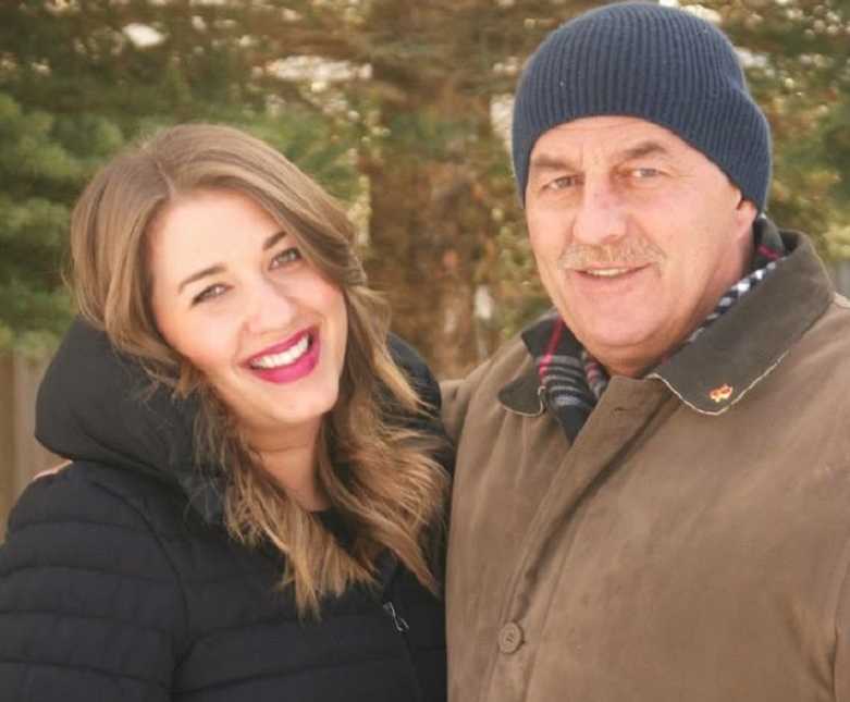 father and daughter smiling in warms coats