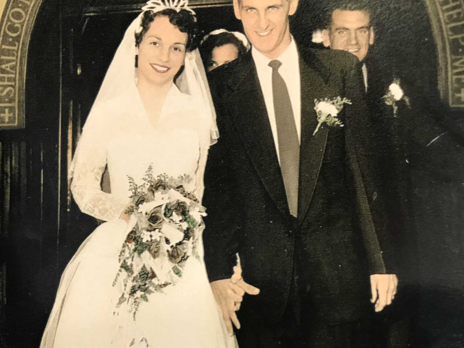 bride and groom hand in hand after wedding 