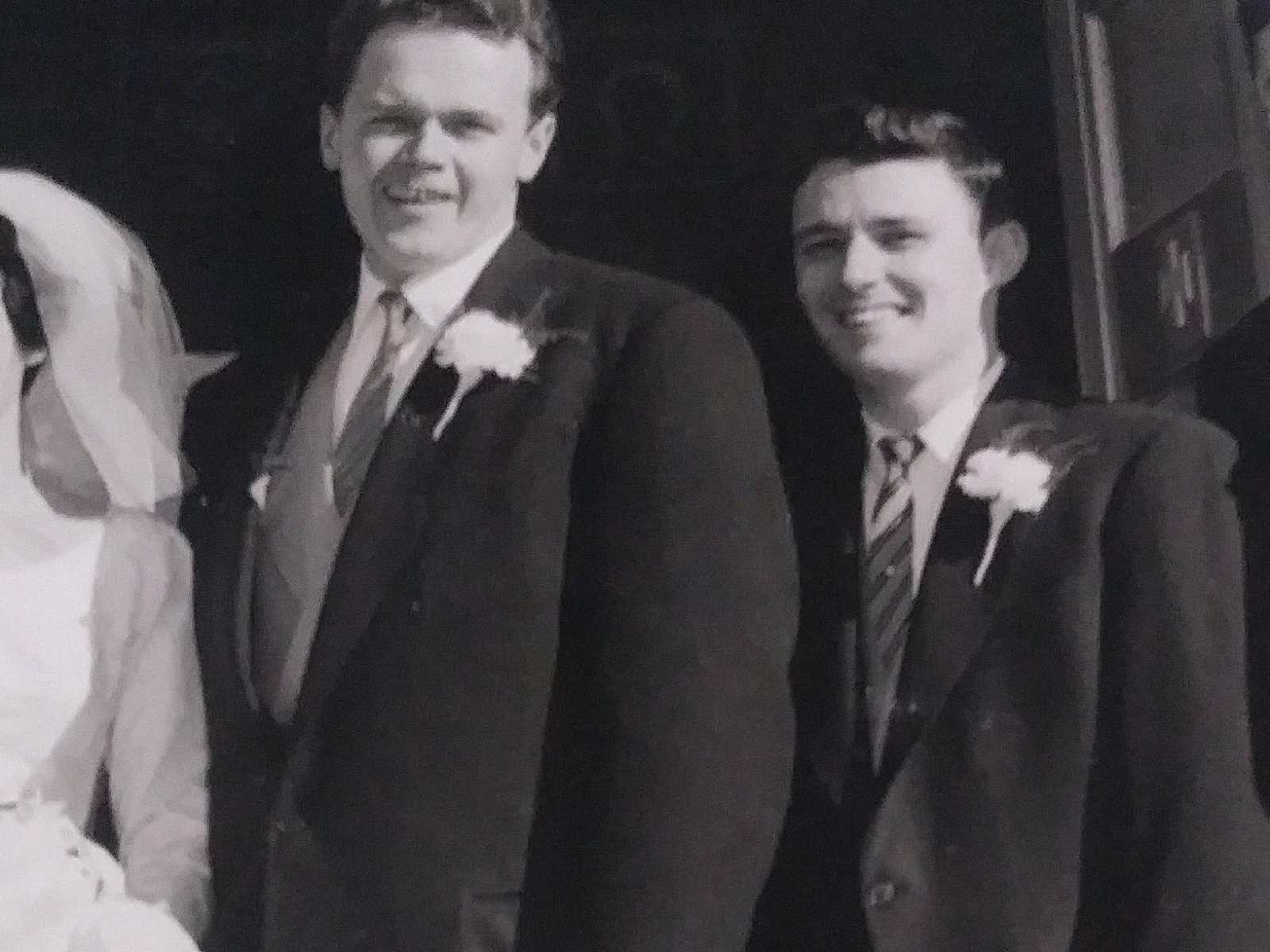 Groom standing beside best man who is his best friend at wedding 