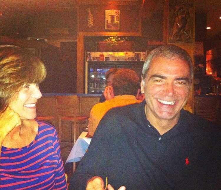 wife smiling at husband while sitting at a restaurant