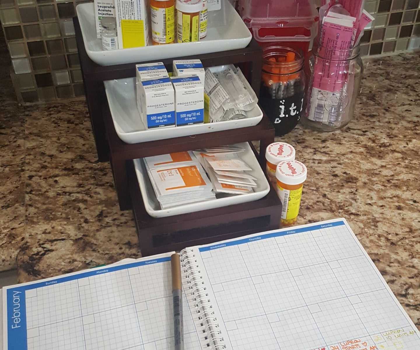 a countertop with a calendar and a bunch of medications