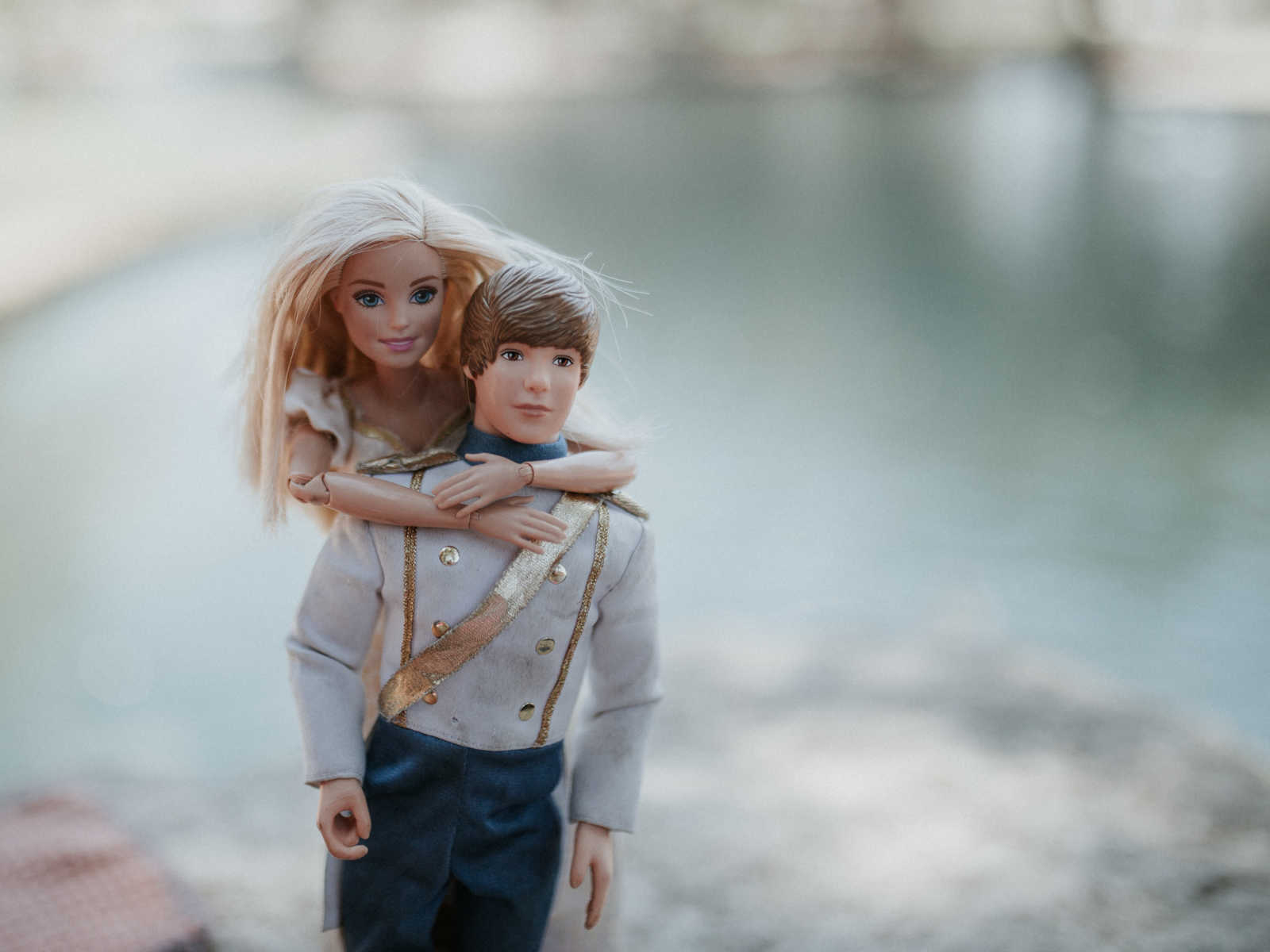 barbie wraps arms around ken who is wearing prince clothing