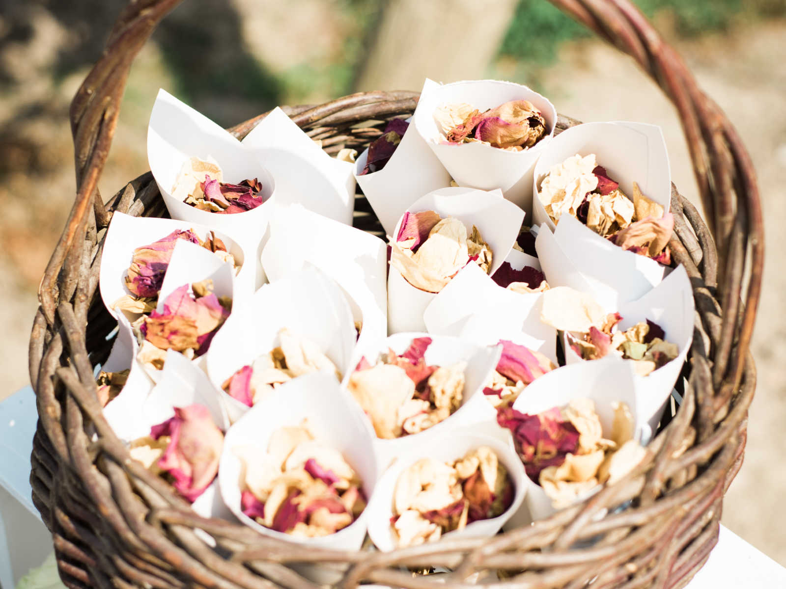 wooden weaved basket with dried red and cream flowers 