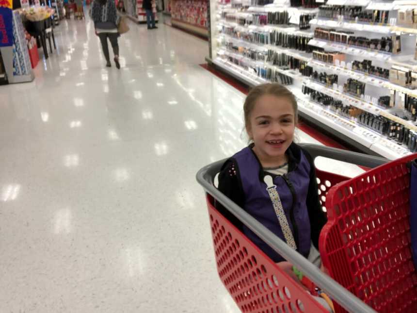 young girl with terminal illness smiles while being pushed in target shopping cart