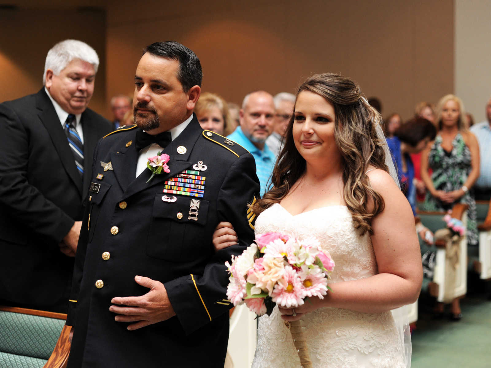 recovered soldier gives away daughter at wedding with guests in the background