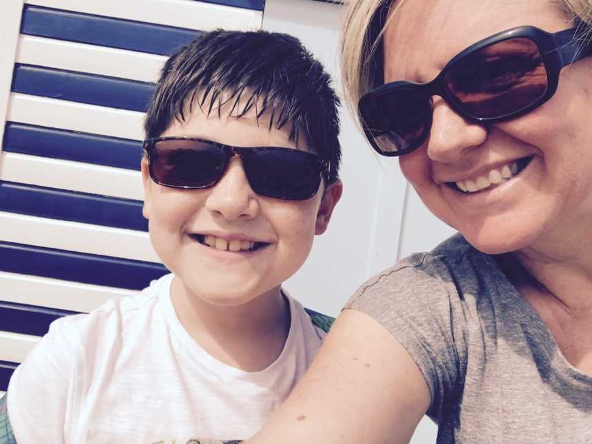 mother and autistic son with sunglasses on smiling in selfie