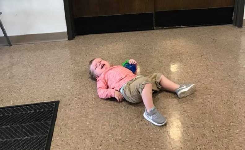 Toddler lying on the floor crying
