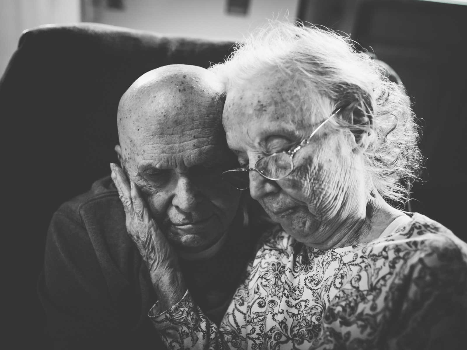 elderly couple in close embrace in black an white