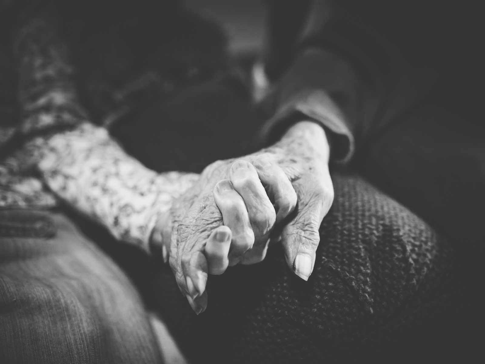 hands being held by elderly couple
