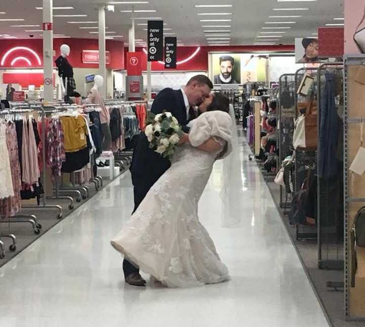 groom dips bride in target aisle