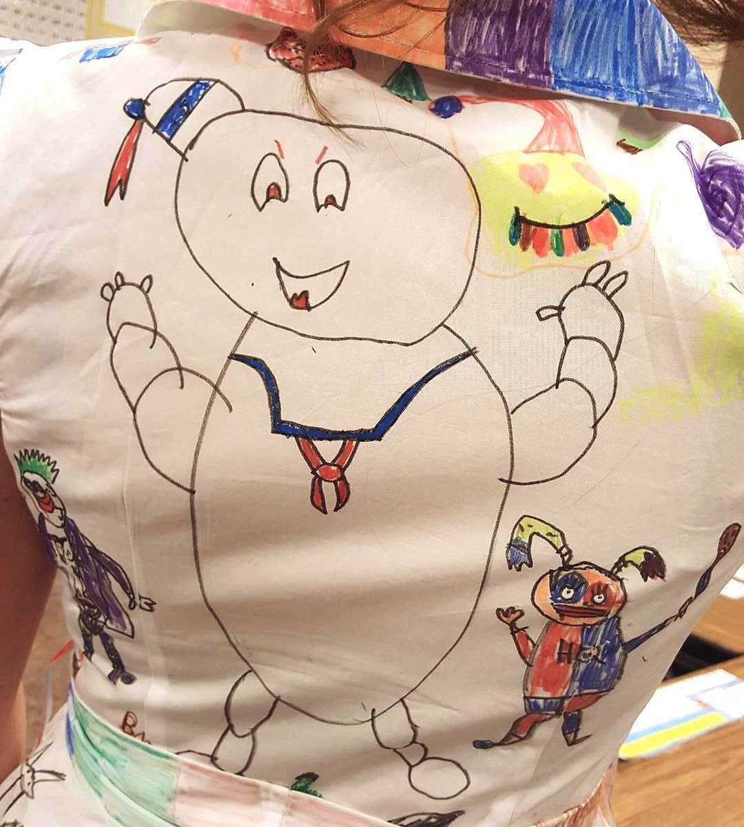 back of teachers dress that has doodle of Michelin man drawing on it