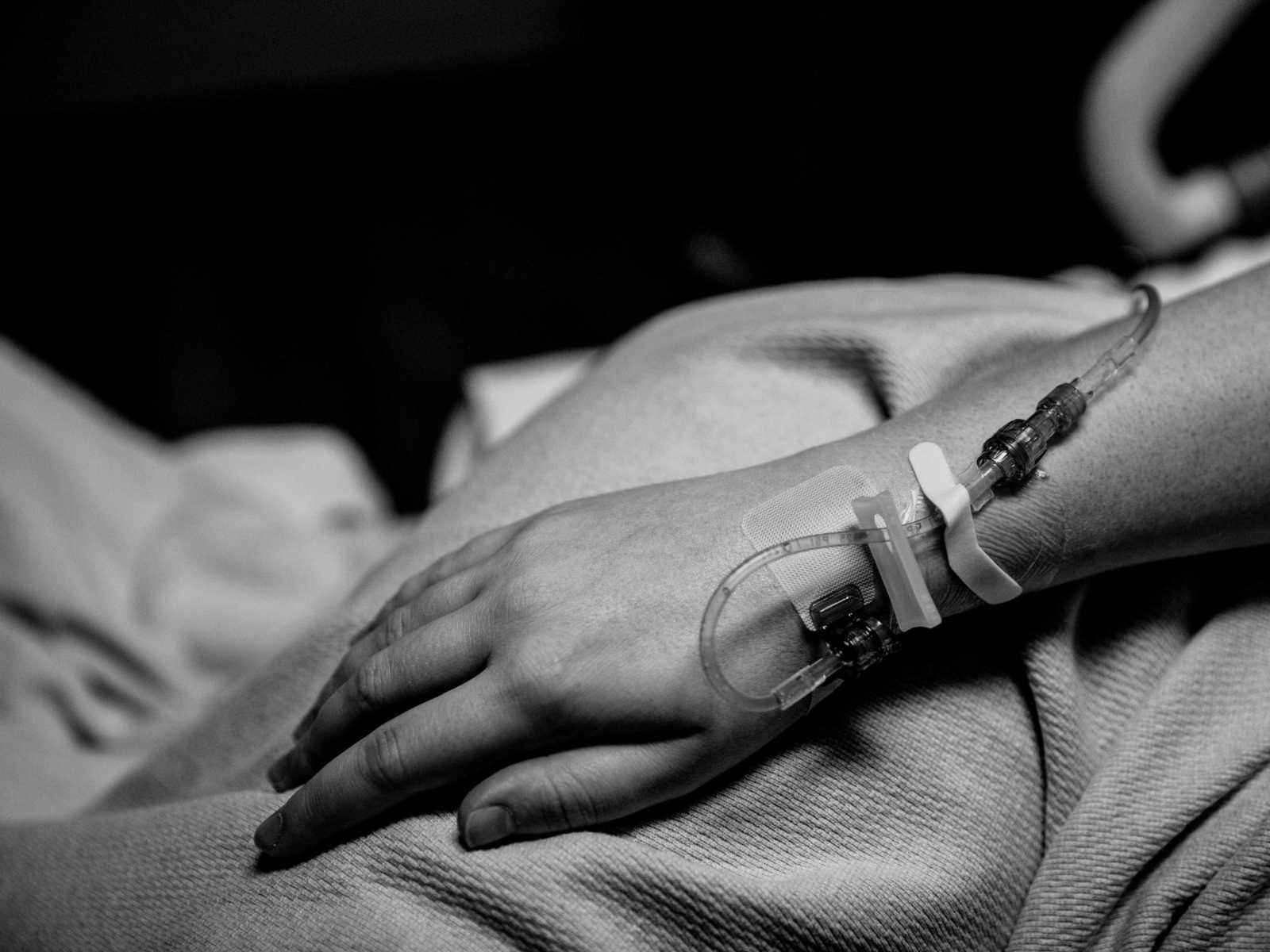 Close up of pregnant woman's hand with IV's attached to it