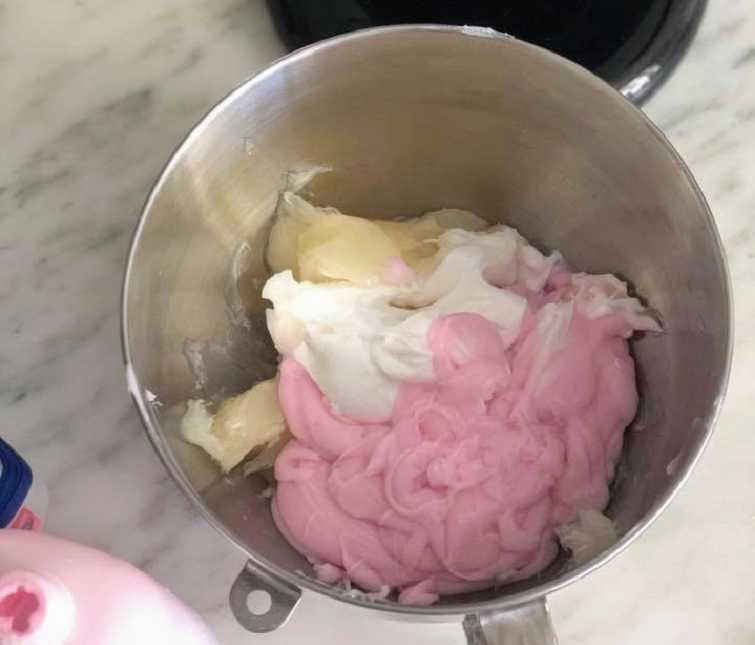 silver mixing bowl with a pink, white, and yellow substance in it