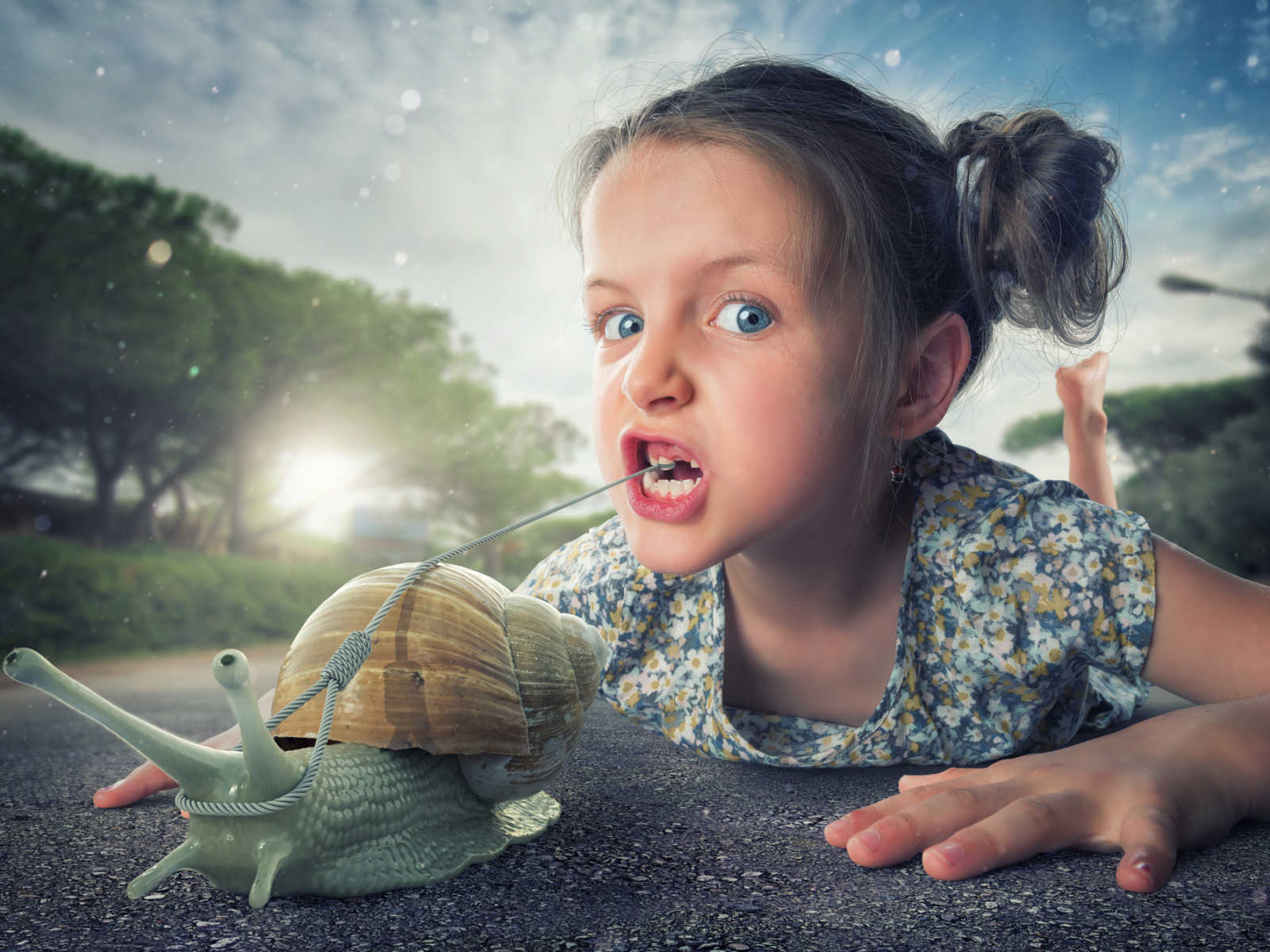 young girl with missing tooth lies on the street with rope leash in mouth that is connected to animated snail