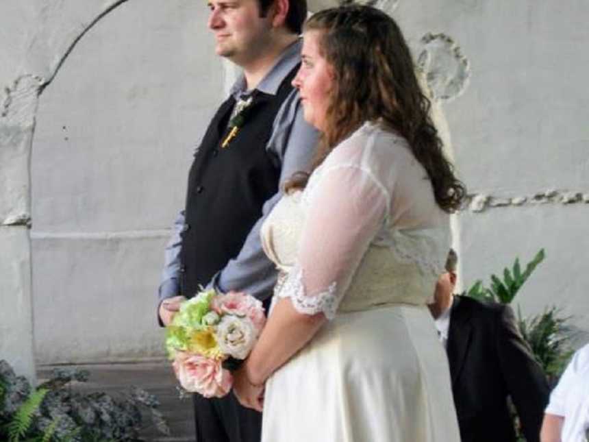 Bride and groom standing at altar during wedding ceremony