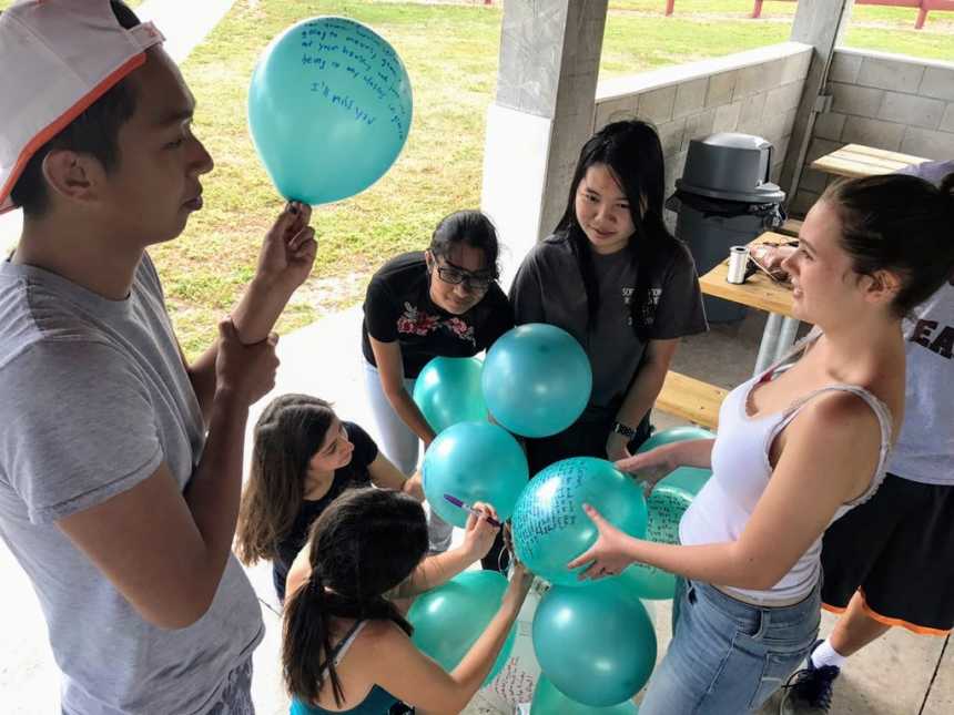 Teens write messages on balloons for classmate who lost her life in Parkland school shooting