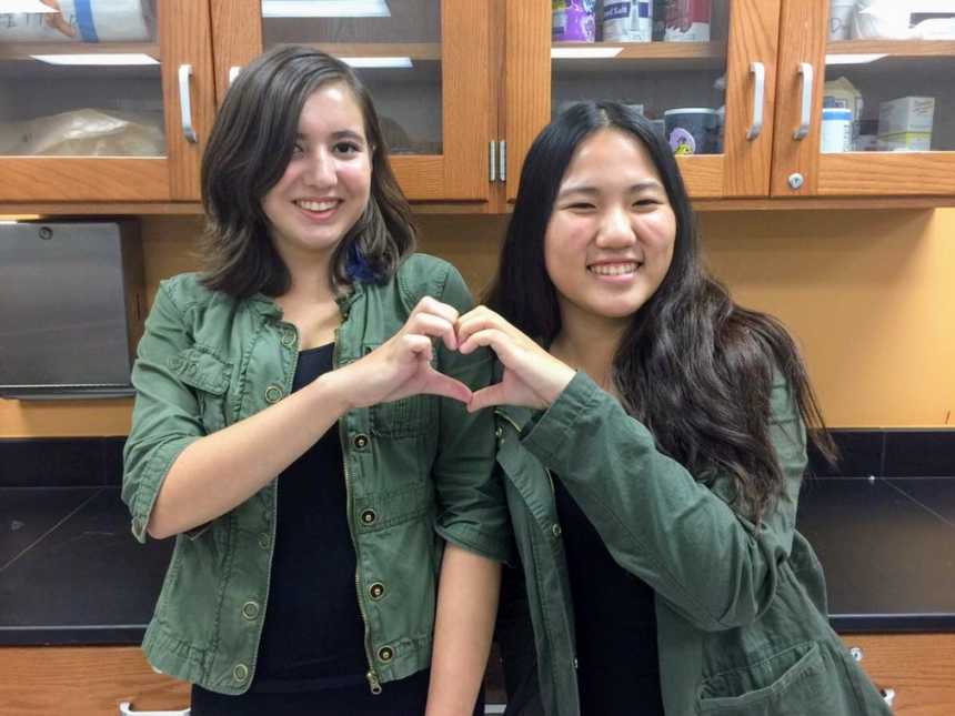 Two teens hold hands up in heart in classroom before one lost her life in Parkland school shooting in Florida