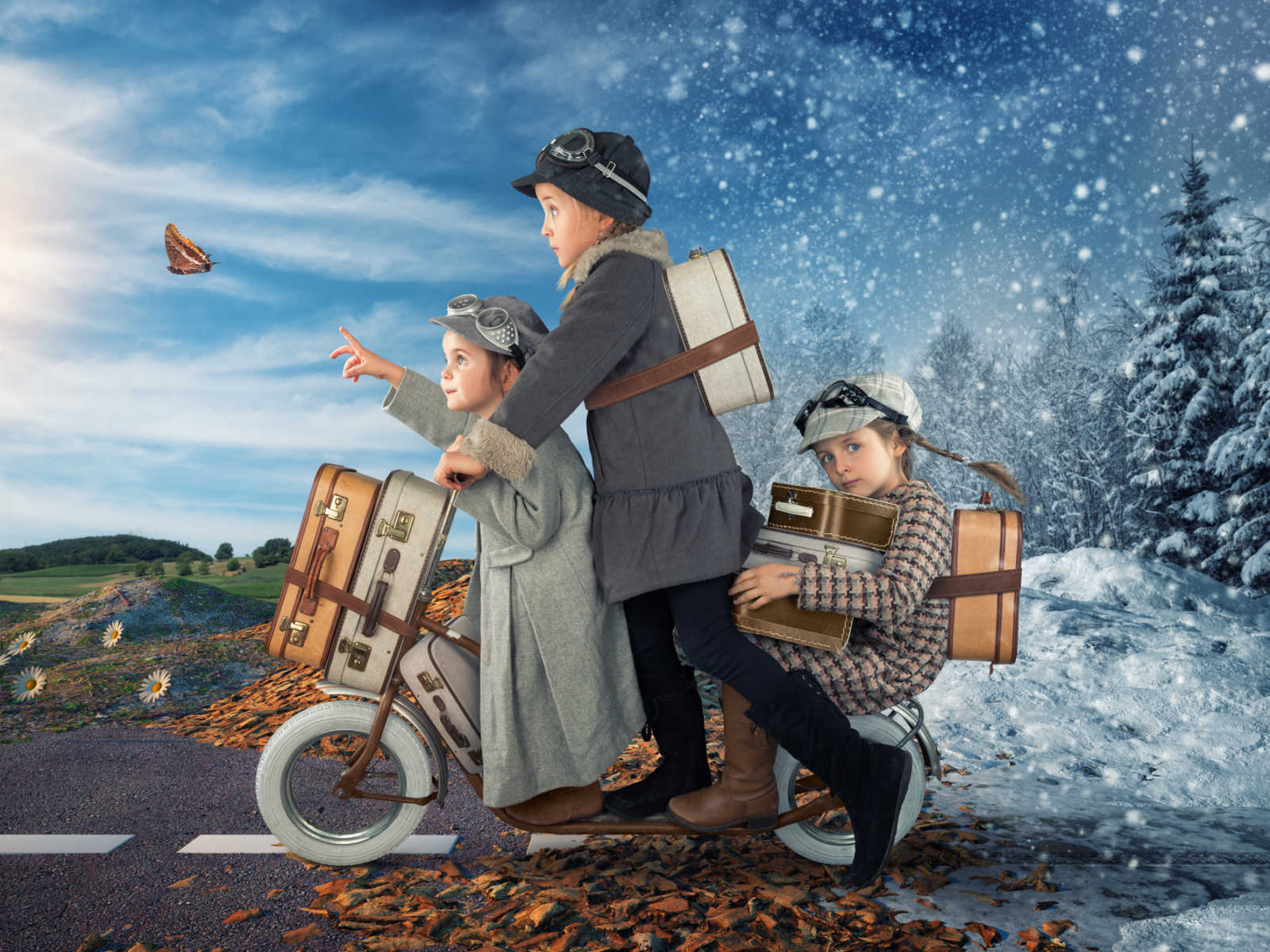 three young girls on a cooter with luggage going towards spring weather and away from winter