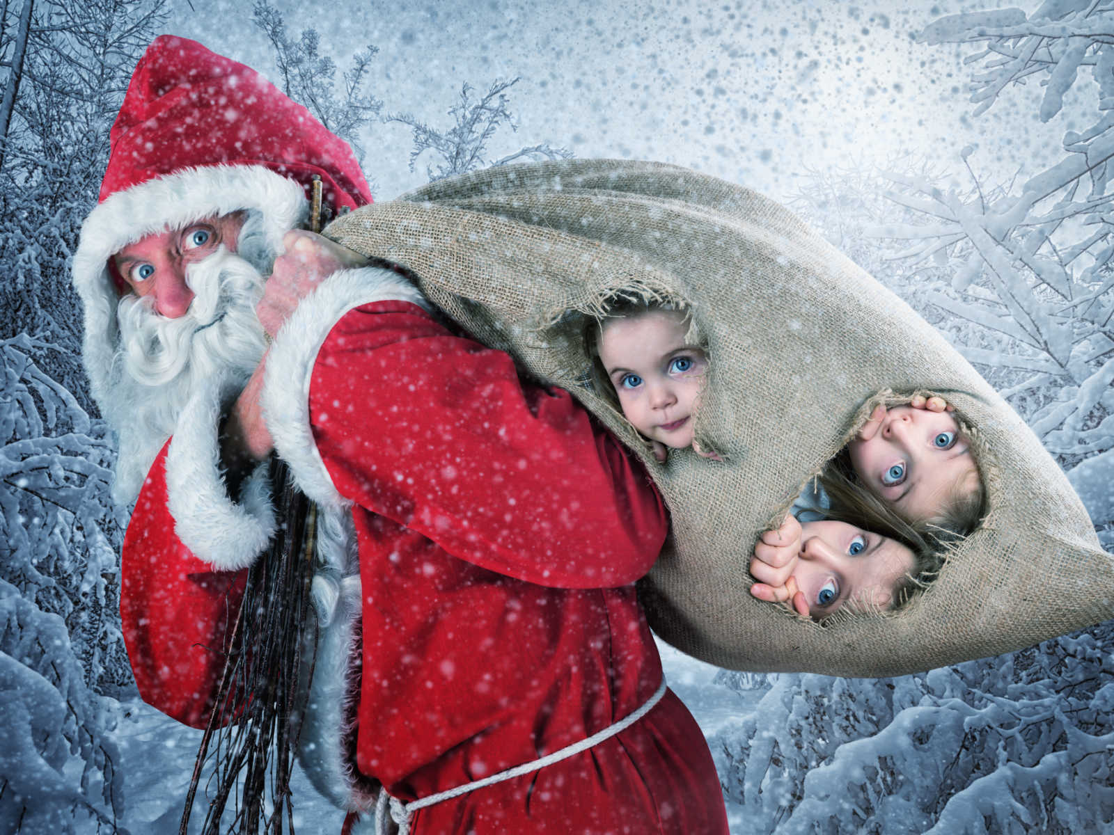santa holding a burlap sack over his shoulder with faces of three girls sticking out