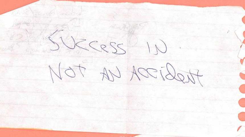 note written on notebook paper that says, "success is not an accident"