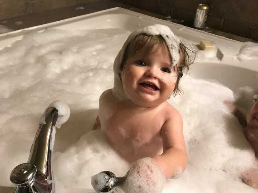 Baby playing in bubble bath