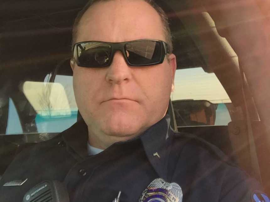 Cop who suffered from pancreatic cancer takes a selfie in cop car in uniform after surgery