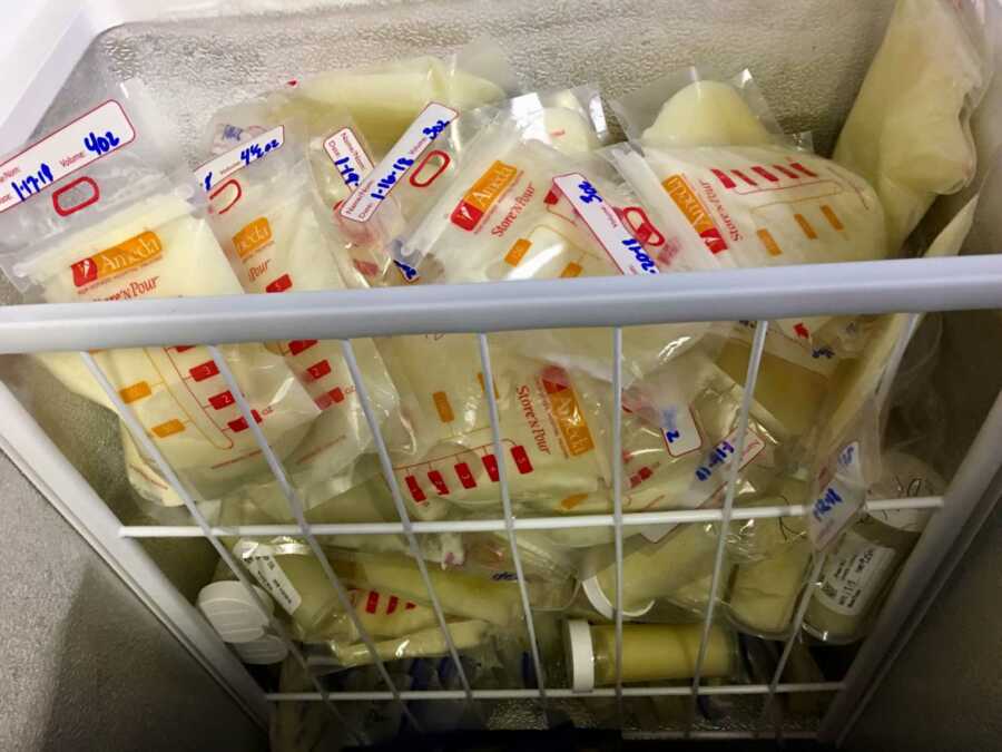 Stack of frozen breast milk inside freezer