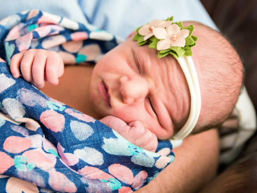 Newborn baby swaddled in blanket