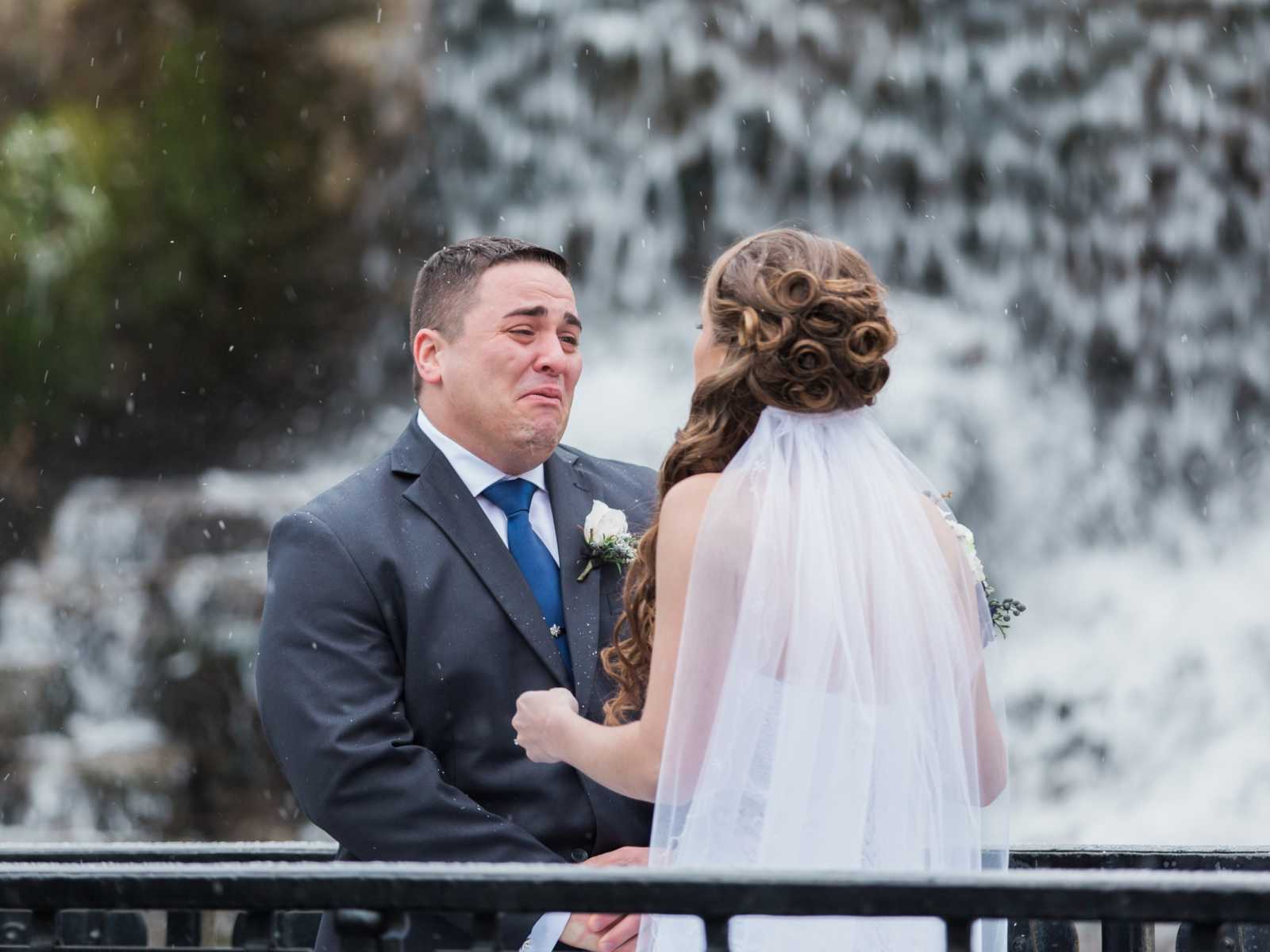 bride and groom face to face with tears coming out of grooms eyes