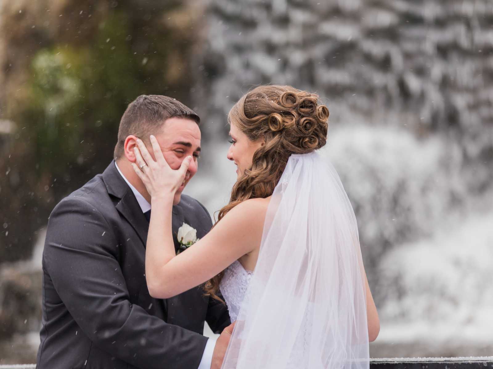 bride wipes away groom's tear