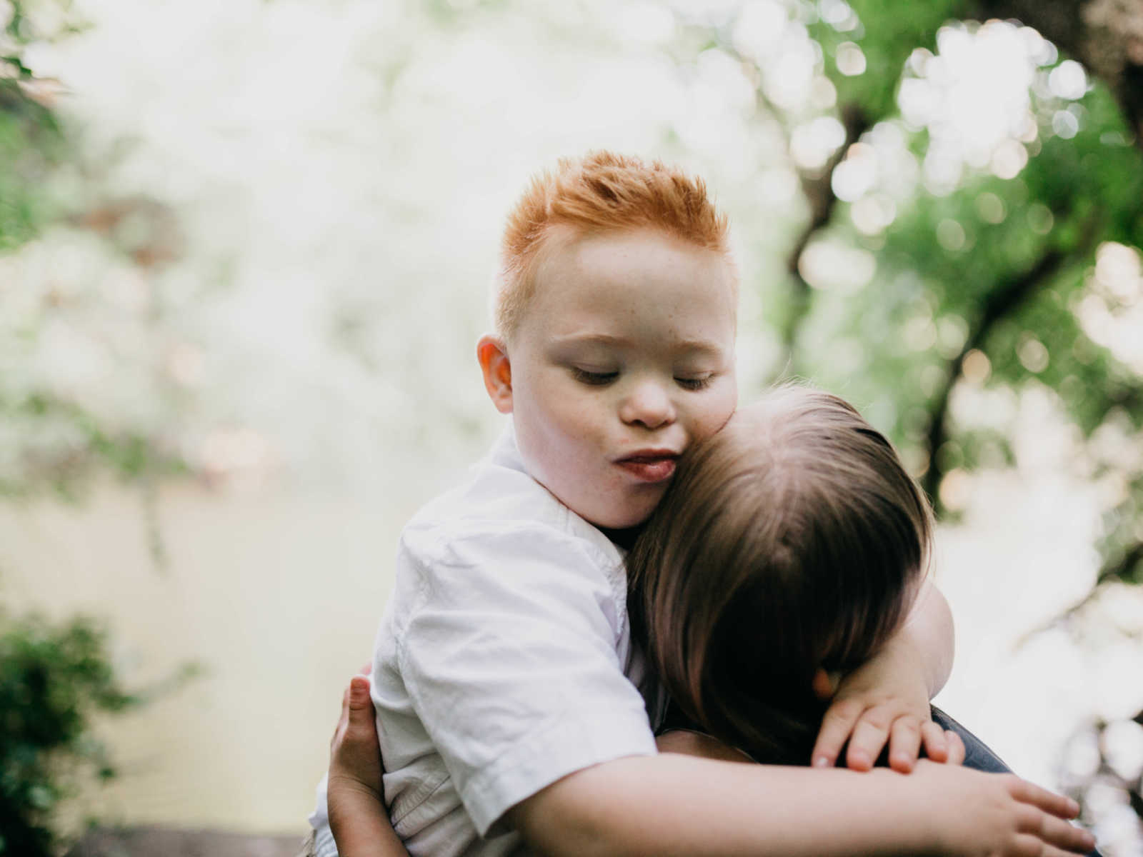 Down syndrome boy hugging down syndrome girl