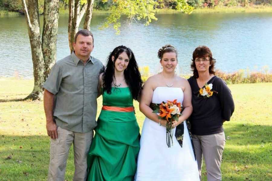 Teen mother and drug addict arm in arm with mother, father, and sister at sister's wedding