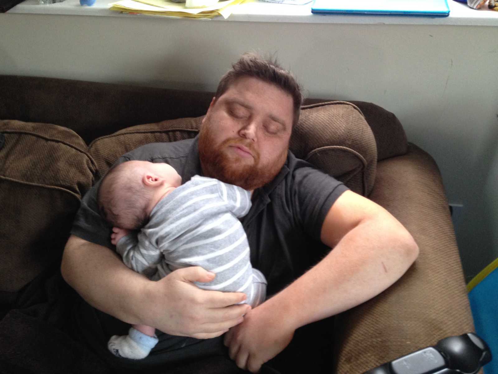 Man who needs kidney transplant when he was younger sleeping with his child on his chest