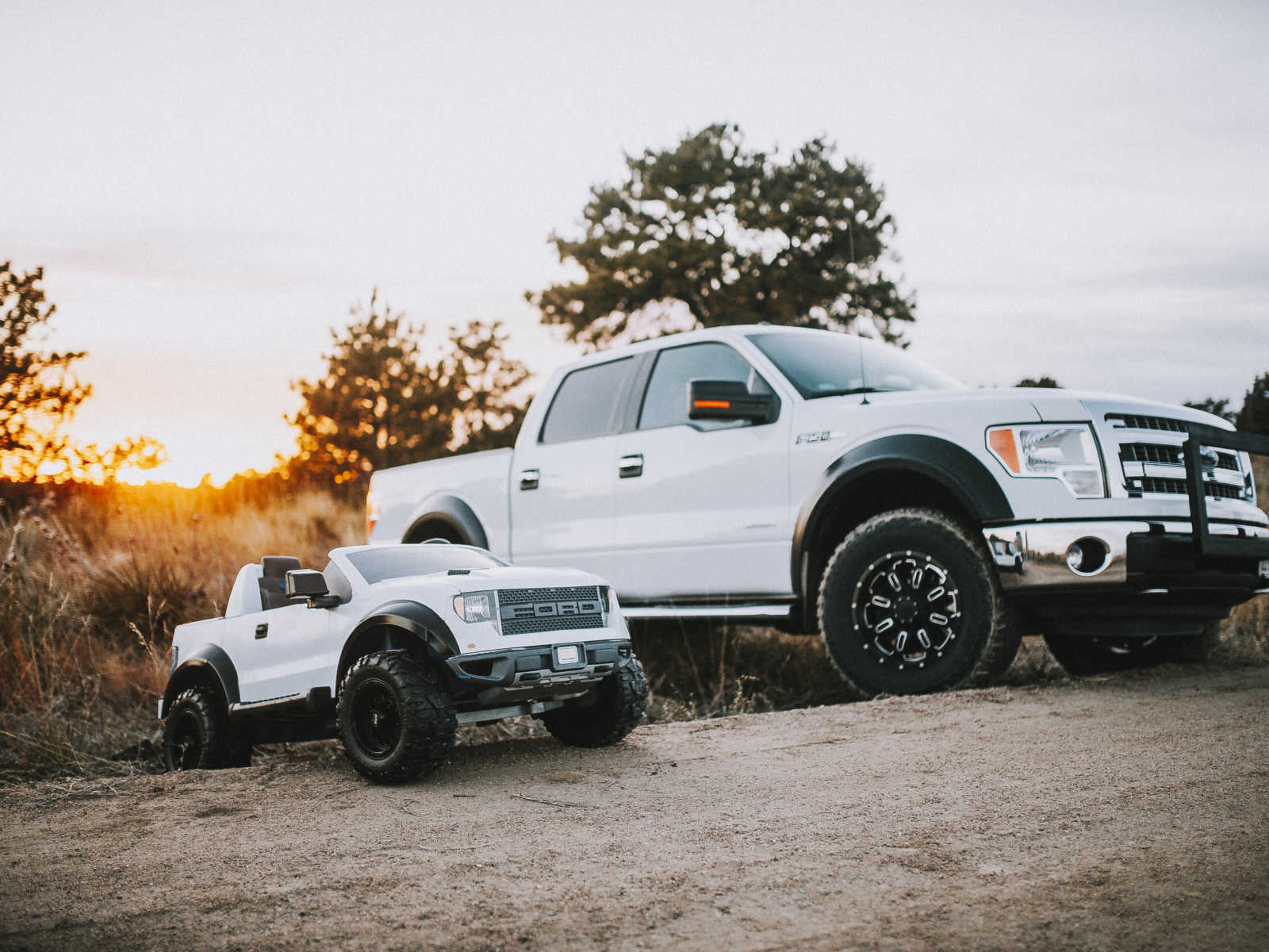 Toy truck parked next to real truck