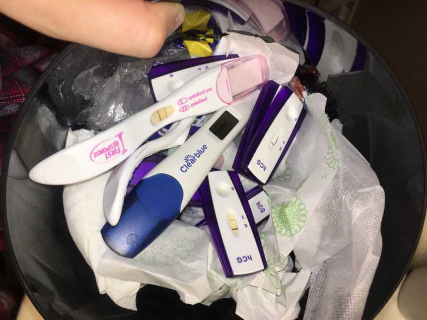 Trash bag full of pregnancy tests that indicate pregnancy 