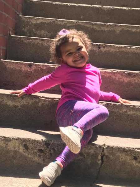 Toddler who was internally decapitated smiles while sitting on steps