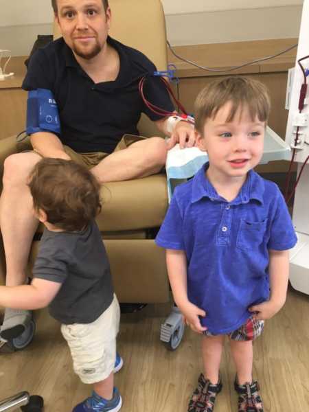 Man who needs kidney transplant get blood drawn while younger sons stand near him