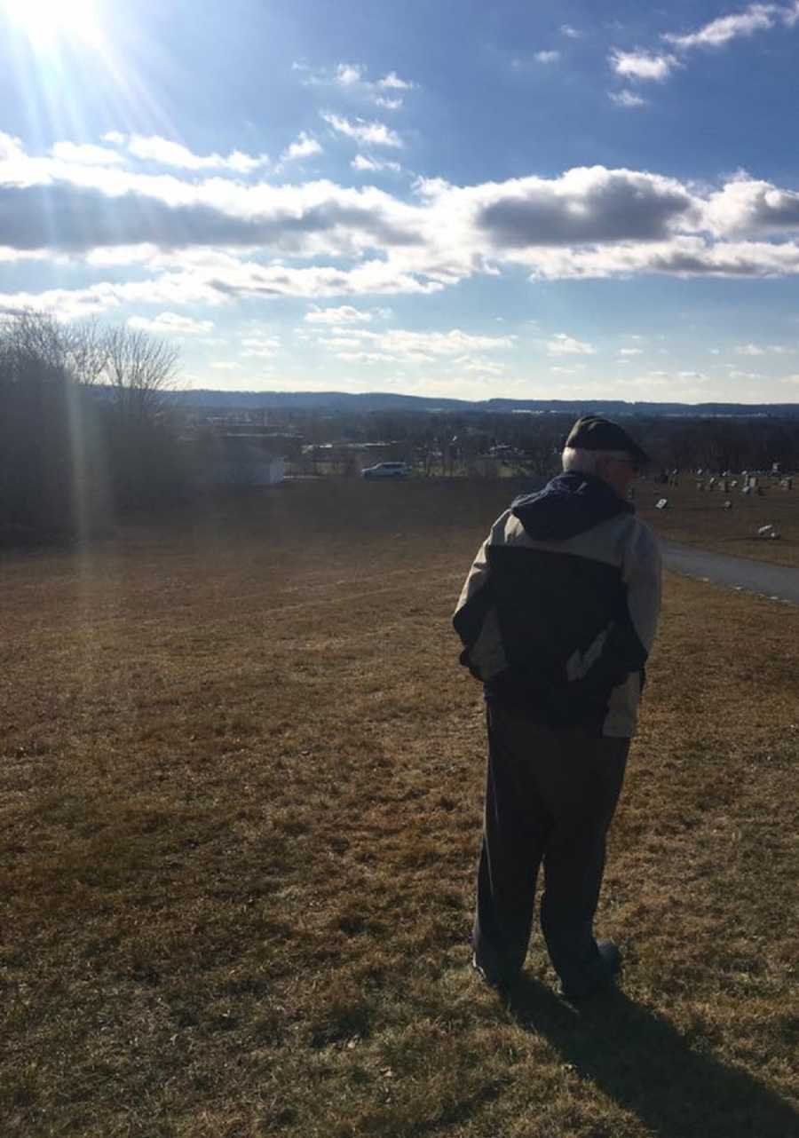 Older man walking towards cemetery