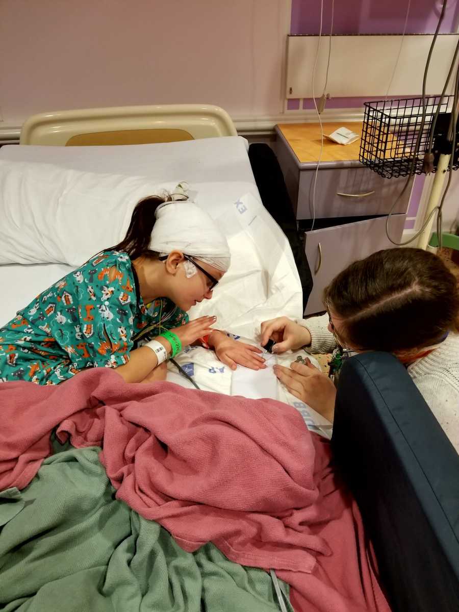 Nine year old girl who suffers from seizures get nails painted while lying in hospital bed