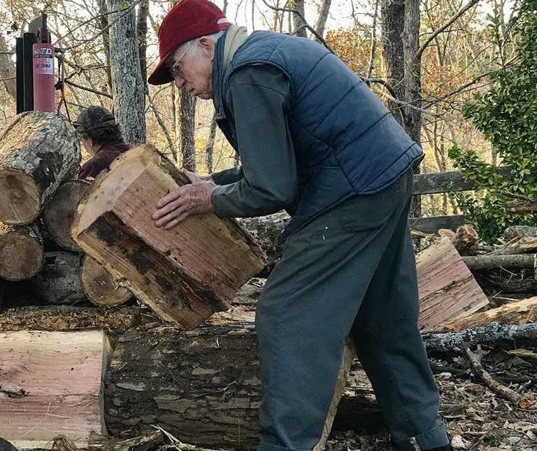 92 year old woman's husband moves big logs in the woods