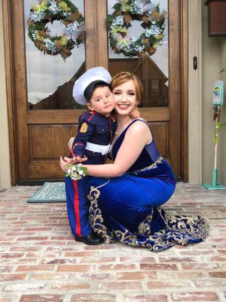 Marine's little brother and girlfriend hug as he is her stand in date for prom