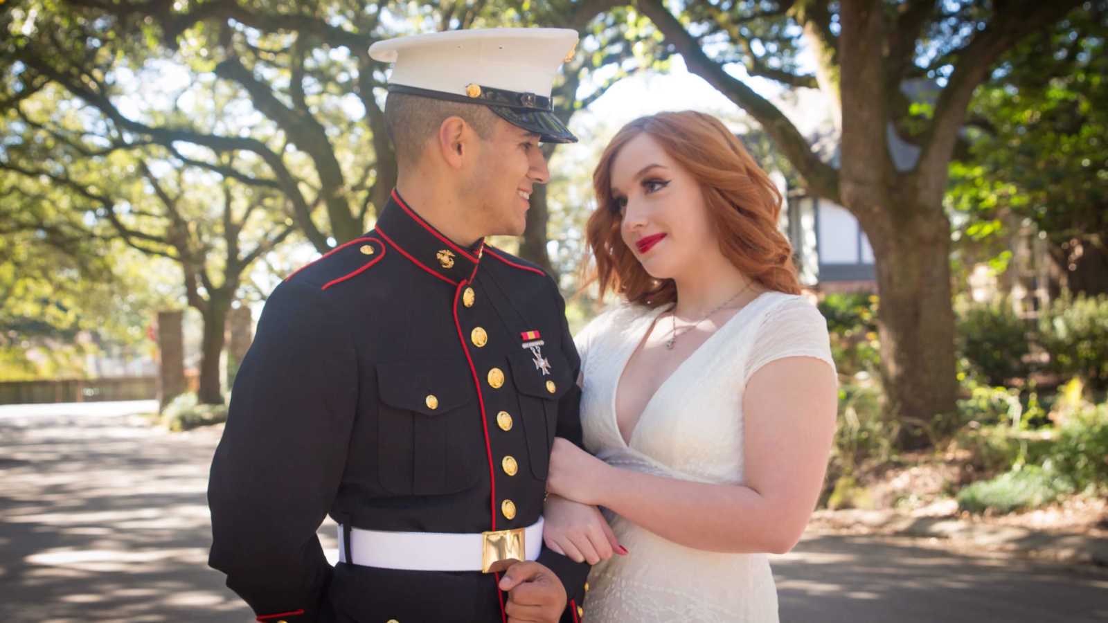 Marine arm and arm looking into the eyes of his girlfriend