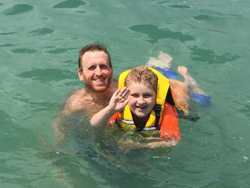 Father who underwent gastric bypass surgery swims in body of water with autistic son