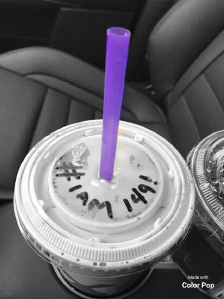 Clear lid with #I am 149! written on it with purple straw to honor woman's late husband