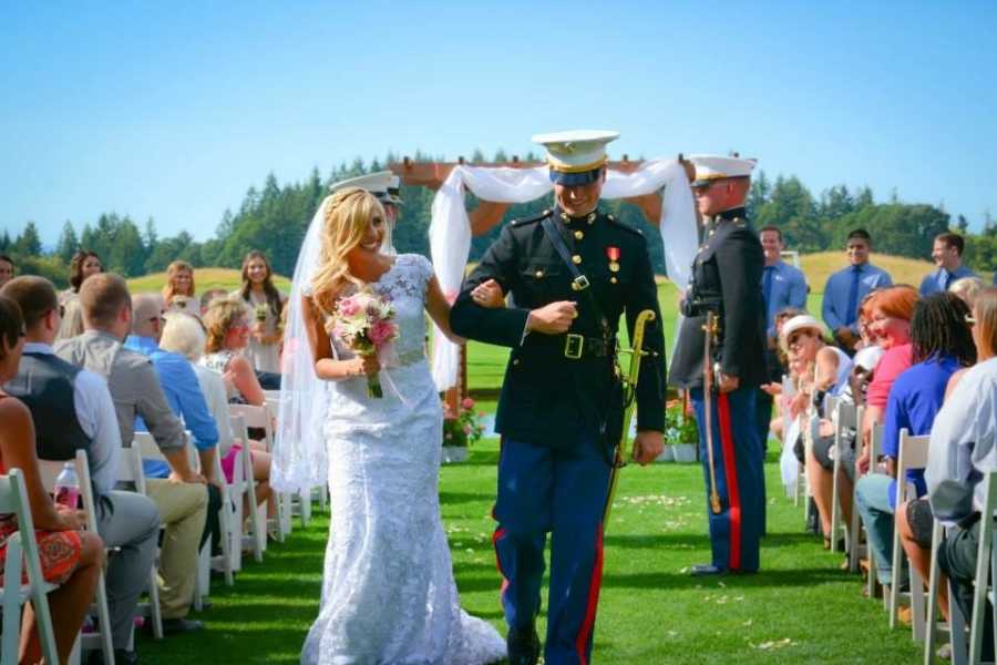 Bride and marine groom walk down the aisle arm and arm at wedding ceremony