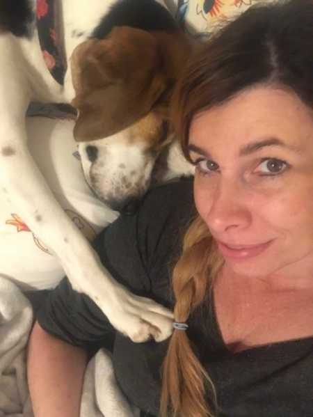 Woman smiles in selfie with dog who discovered skin cancer on her nose