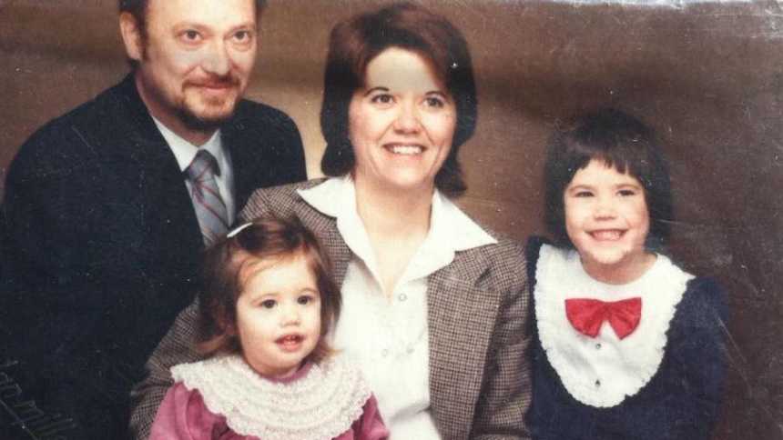 Woman with small cell cancer when she was younger smiling with husband and two daughters