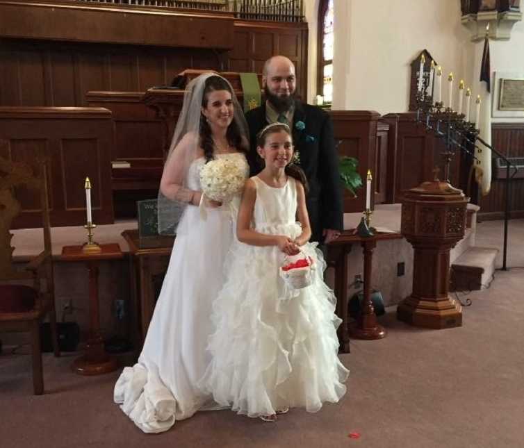Teen mother and former drug addict clean at wedding standing with husband and daughter