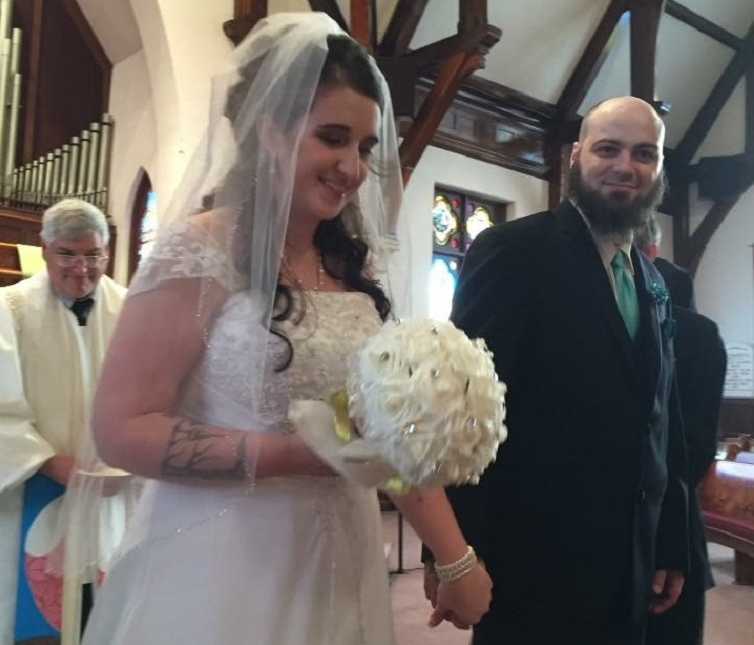 Teen mother and former drug addict walks away from altar smiling with husband